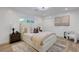 Bright bedroom with a large window, neutral tones, and decorative art, creating a serene and inviting atmosphere at 7140 Palmyra Ave, Las Vegas, NV 89117