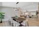 Dining room with wood table, seating for eight, and view into the Gathering room at 7140 Palmyra Ave, Las Vegas, NV 89117