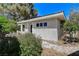 Charming home with stucco exterior and lush greenery in a well-maintained yard at 7140 Palmyra Ave, Las Vegas, NV 89117