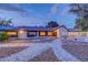 Charming single-story home with desert landscaping, well-lit exterior, and modern garage doors at 7140 Palmyra Ave, Las Vegas, NV 89117