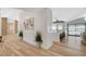Hallway view leading to a kitchen with barstool seating and a sliding glass door to the backyard pool at 7140 Palmyra Ave, Las Vegas, NV 89117