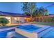 Relaxing hot tub adjacent to a sparkling pool and well-manicured yard, creating a private and inviting outdoor retreat at 7140 Palmyra Ave, Las Vegas, NV 89117