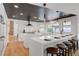 Bright open kitchen with bar seating, white marble countertops, and stainless steel hood at 7140 Palmyra Ave, Las Vegas, NV 89117