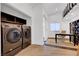 Modern laundry room features sleek washer and dryer units, built-in shelving, and an adjacent office area at 7140 Palmyra Ave, Las Vegas, NV 89117