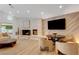 Cozy living room with stone fireplace, modern decor, and a mounted TV for entertainment at 7140 Palmyra Ave, Las Vegas, NV 89117