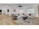 Bright living room featuring a large white sofa, area rug, fan, and ample natural light from the windows at 7140 Palmyra Ave, Las Vegas, NV 89117