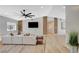 Bright living room with large sectional sofa, modern lighting, and hardwood floors at 7140 Palmyra Ave, Las Vegas, NV 89117