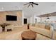 Comfortable living room with modern decor, TV, open to the kitchen, and hardwood flooring at 7140 Palmyra Ave, Las Vegas, NV 89117