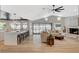 Open concept living room with fireplace and kitchen views, featuring hardwood flooring at 7140 Palmyra Ave, Las Vegas, NV 89117