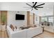 Open-concept living room featuring modern decor, a large sectional sofa, and a dining area at 7140 Palmyra Ave, Las Vegas, NV 89117