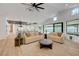 Inviting living room with modern furnishings, access to backyard patio, and an open kitchen concept at 7140 Palmyra Ave, Las Vegas, NV 89117