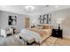 Serene main bedroom with stylish wallpaper, a plush bed, and a cozy sitting area at 7140 Palmyra Ave, Las Vegas, NV 89117