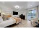 Bright main bedroom with modern finishes, access to outdoor space, and en-suite bathroom at 7140 Palmyra Ave, Las Vegas, NV 89117
