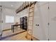 Home office featuring a sliding ladder for the built-in shelving, desk and chair at 7140 Palmyra Ave, Las Vegas, NV 89117