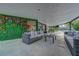 Spacious patio with a green wall feature and cozy seating, ideal for outdoor relaxation at 7140 Palmyra Ave, Las Vegas, NV 89117