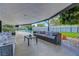 Spacious outdoor patio with comfortable seating overlooking a pool and well-manicured backyard at 7140 Palmyra Ave, Las Vegas, NV 89117