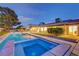 Beautiful backyard featuring a sparkling pool, hot tub, and manicured lawn, perfect for enjoying outdoor living and leisure at 7140 Palmyra Ave, Las Vegas, NV 89117