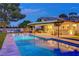 Inviting pool area with modern lounge chairs and ambient lighting, creating a serene outdoor oasis for relaxation and entertainment at 7140 Palmyra Ave, Las Vegas, NV 89117