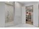 Contemporary shower with marble tile and an attached walk in closet with built-in storage and organization at 7140 Palmyra Ave, Las Vegas, NV 89117