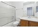 Well-lit bathroom with a shower over tub, a toilet, and a sink with vanity at 7331 Carrot Ridge St, Las Vegas, NV 89139
