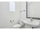 Clean bathroom featuring a modern toilet, sink, mirror, and a window with horizontal blinds at 7331 Carrot Ridge St, Las Vegas, NV 89139