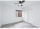 Bright bedroom featuring wood-look floors, a ceiling fan, a window with blinds, and a closet with sliding doors at 7331 Carrot Ridge St, Las Vegas, NV 89139