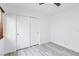 Bright bedroom featuring wood-look floors, a window with blinds, and a closet with sliding doors at 7331 Carrot Ridge St, Las Vegas, NV 89139