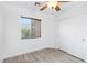 Bright bedroom featuring wood-look floors, a ceiling fan, a window with blinds, and a closet with sliding doors at 7331 Carrot Ridge St, Las Vegas, NV 89139