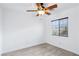 Bright bedroom with ceiling fan, window with blinds, and wood floors at 7331 Carrot Ridge St, Las Vegas, NV 89139