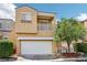 Two-story home featuring a balcony, two car garage, and desert landscaping at 7331 Carrot Ridge St, Las Vegas, NV 89139