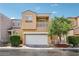 Inviting two-story home featuring a balcony, a two-car garage, and charming landscaping at 7331 Carrot Ridge St, Las Vegas, NV 89139