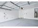 Spacious garage with painted floors, an automatic door opener, and utility connections at 7331 Carrot Ridge St, Las Vegas, NV 89139