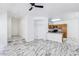 Open-concept living room featuring marble floors, stairs, and a partial kitchen view at 7331 Carrot Ridge St, Las Vegas, NV 89139