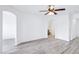 Open-concept living room featuring wood floors, arches, and a ceiling fan with lighting at 7331 Carrot Ridge St, Las Vegas, NV 89139