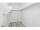 Walk-in closet with built-in shelving and wood floor at 7331 Carrot Ridge St, Las Vegas, NV 89139