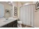 A well-maintained bathroom with a single vanity, modern fixtures, and tiled shower-tub combo is clean and functional at 7340 Zonal Ave, Las Vegas, NV 89131