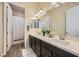 An immaculate bathroom with double sinks, a large mirror, and wood-look tile, providing an elegant feel at 7340 Zonal Ave, Las Vegas, NV 89131