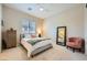 Bright bedroom with large window, ceiling fan, and neutral decor exudes coziness and a calming atmosphere at 7340 Zonal Ave, Las Vegas, NV 89131