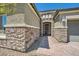 Inviting front entrance with a stone facade, paver walkway, and a dark wood door at 7340 Zonal Ave, Las Vegas, NV 89131