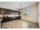 A spacious kitchen featuring dark wood cabinetry, granite countertops, and hardwood floors offers ample storage at 7340 Zonal Ave, Las Vegas, NV 89131