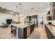 Open concept kitchen featuring a large island with sink and seating, flowing into the living area at 7340 Zonal Ave, Las Vegas, NV 89131