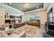 Open-concept living room with wood-style tile flooring and views into the kitchen and dining areas at 7340 Zonal Ave, Las Vegas, NV 89131
