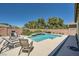 Beautiful pool area with lounge chairs, a built-in spa, and privacy landscaping at 7340 Zonal Ave, Las Vegas, NV 89131