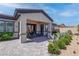 Landscaped backyard highlighting covered patio, desert plants, and access to the home at 7416 Deschutes Cir, Las Vegas, NV 89129