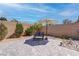 Charming backyard featuring brick wall, desert landscaping, and an umbrella-shaded seating area on paved flooring at 7416 Deschutes Cir, Las Vegas, NV 89129
