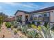 Well-maintained backyard featuring desert landscaping, rock features, and a covered patio with outdoor seating at 7416 Deschutes Cir, Las Vegas, NV 89129