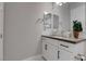 This bathroom features white cabinets, a dark countertop, and a large mirror at 7416 Deschutes Cir, Las Vegas, NV 89129