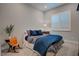 This bedroom boasts a comfy bed with stylish bedding and a bedside table with a lamp at 7416 Deschutes Cir, Las Vegas, NV 89129