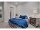 Charming bedroom with a plush bed, stylish bedding, and a vintage-style nightstand at 7416 Deschutes Cir, Las Vegas, NV 89129