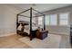 Cozy bedroom with a four-poster bed, wood floors, and plantation shutters at 7416 Deschutes Cir, Las Vegas, NV 89129